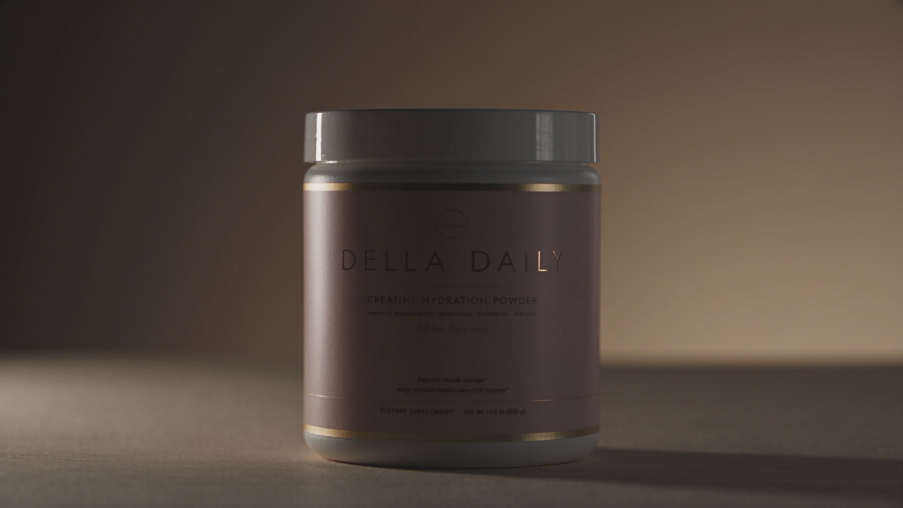 Light slowly reveals a Della Daily creatine hydration powder jar